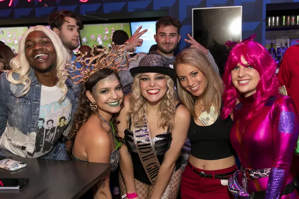 Friends in Halloween costumes at a Downtown Crawlers bar crawl